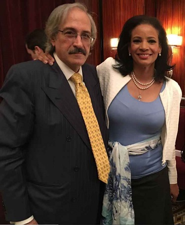 Green posing with her spouse Ted Nikolis